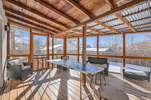 sunroom / solarium featuring lofted ceiling and wood ceiling