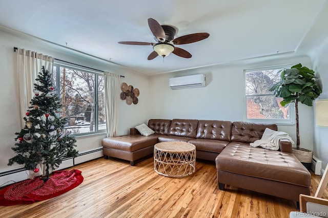 living room featuring a baseboard heating unit, a wall unit AC, wood finished floors, and ceiling fan