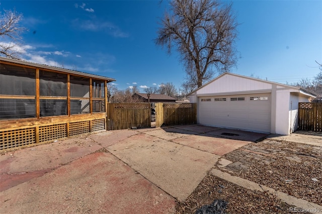 detached garage featuring a gate and fence