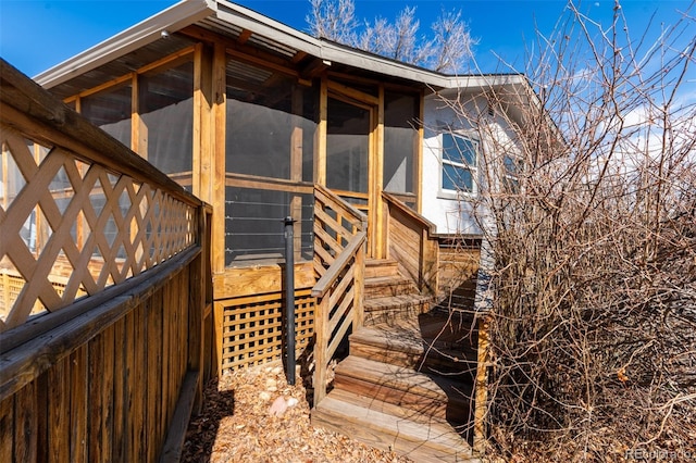 view of side of home featuring a sunroom