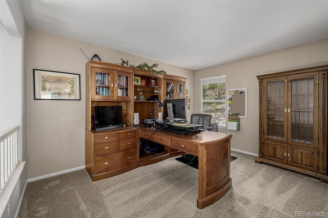 carpeted office featuring baseboards