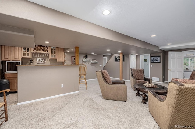 living room featuring bar, light colored carpet, baseboards, and recessed lighting