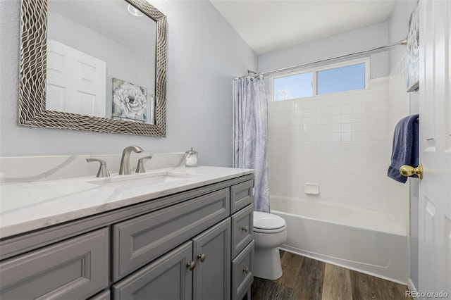 bathroom with toilet, vanity, wood finished floors, and shower / bath combination with curtain