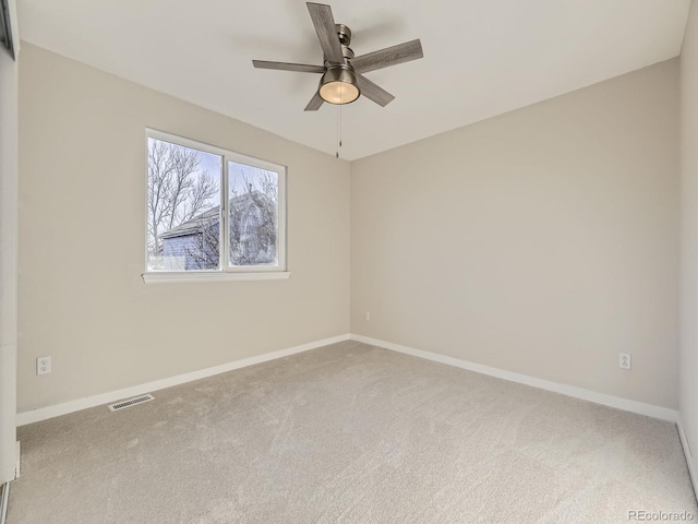 empty room featuring carpet flooring and ceiling fan