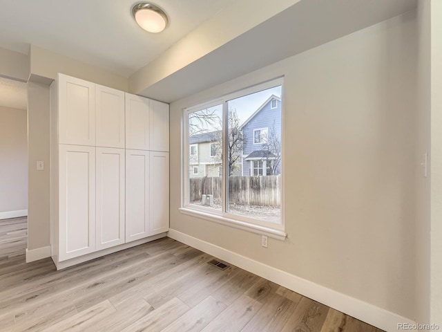 unfurnished bedroom with a closet and light hardwood / wood-style flooring