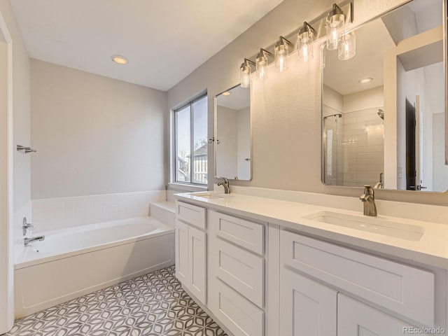 bathroom featuring tile patterned floors, vanity, and shower with separate bathtub