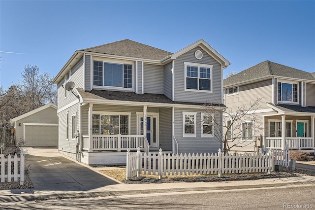 traditional-style home with a fenced front yard, covered porch, a shingled roof, an outdoor structure, and a detached garage