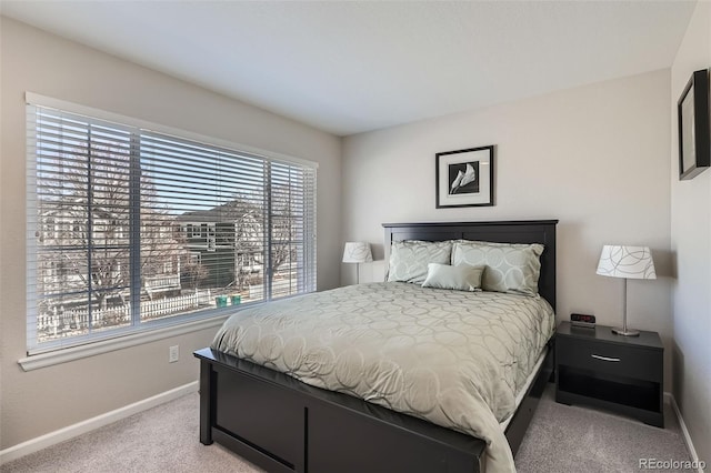 carpeted bedroom featuring baseboards