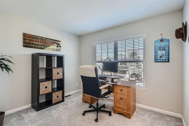 home office featuring light colored carpet, visible vents, and baseboards