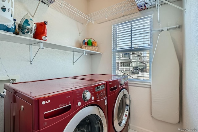 washroom featuring a healthy amount of sunlight, laundry area, and washer and dryer