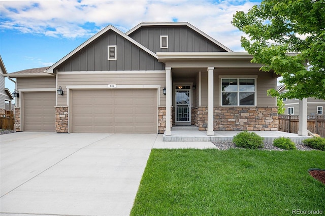 craftsman inspired home with a garage, covered porch, and a front yard