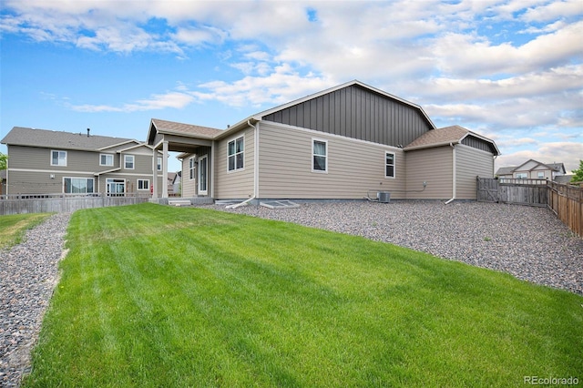 rear view of property with a yard