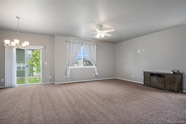 unfurnished living room with ceiling fan with notable chandelier and carpet floors