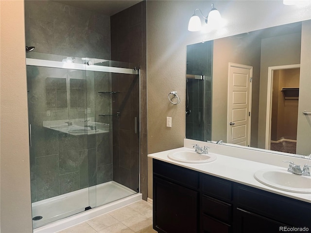 bathroom with tile patterned flooring, vanity, and an enclosed shower