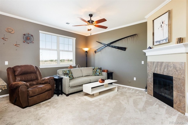 carpeted living room featuring a fireplace, ornamental molding, and a ceiling fan