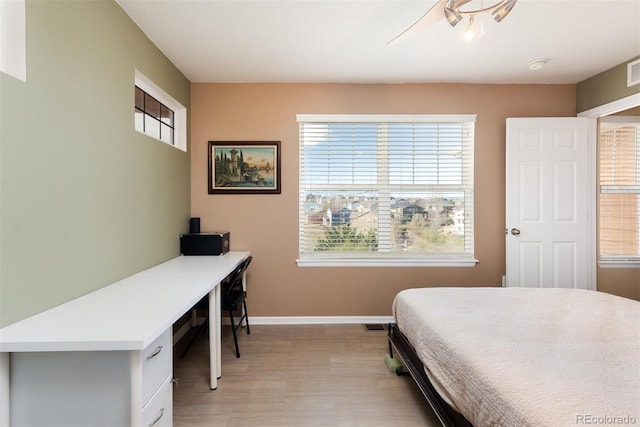 bedroom featuring baseboards and light wood-style floors