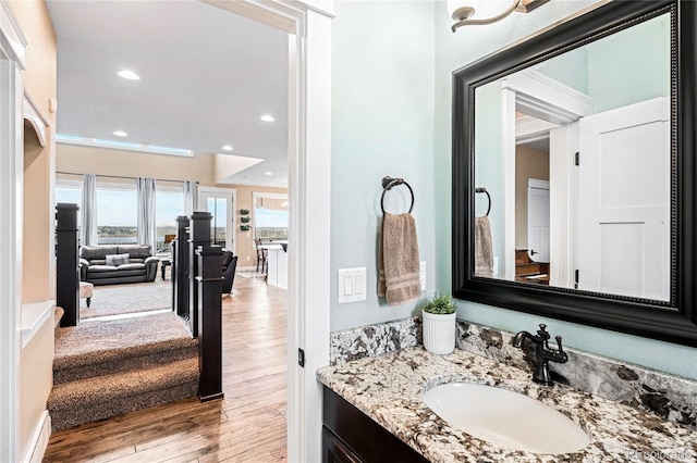 12648 Waterside Ln, Longmont, CO 80504 - bathroom featuring wood finished floors, vanity, and recessed lighting
