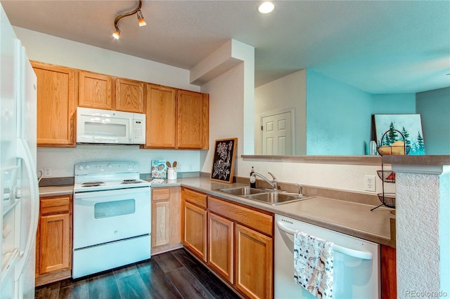 kitchen featuring kitchen peninsula, sink, dark wood-type flooring, and white appliances