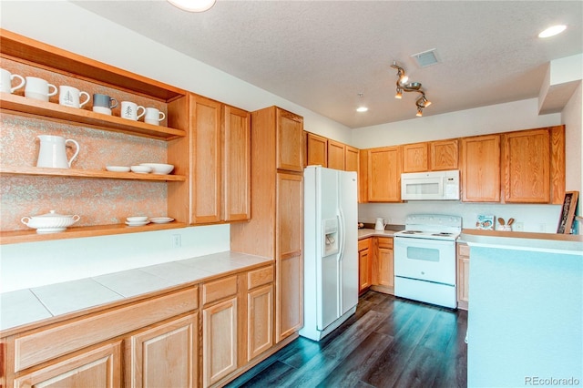 kitchen featuring a textured ceiling, tile counters, dark hardwood / wood-style floors, and white appliances