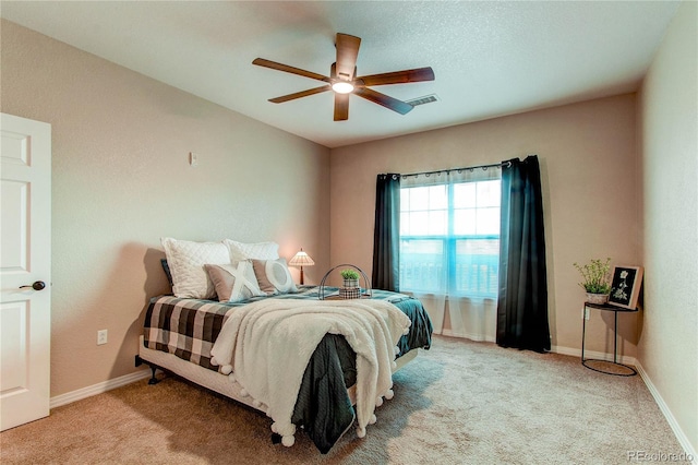 bedroom with ceiling fan and light carpet