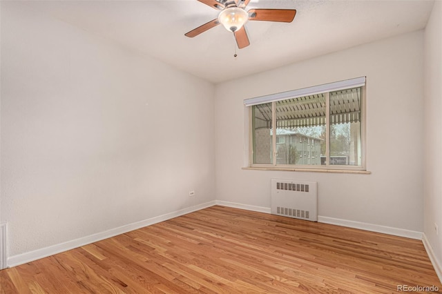 1454 Jersey St Unit 104, Denver, CO 80220 - empty room with radiator, light wood finished floors, ceiling fan, and baseboards