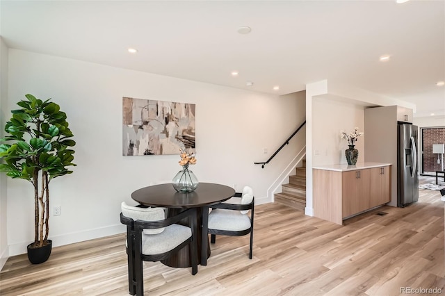 115 W 2nd Ave Unit 101, Denver, CO 80223 - dining room featuring light wood-style floors, stairs, and recessed lighting