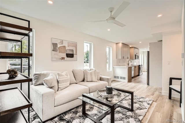 115 W 2nd Ave Unit 101, Denver, CO 80223 - living room featuring healthy amount of natural light, a ceiling fan, light wood-style floors, and recessed lighting