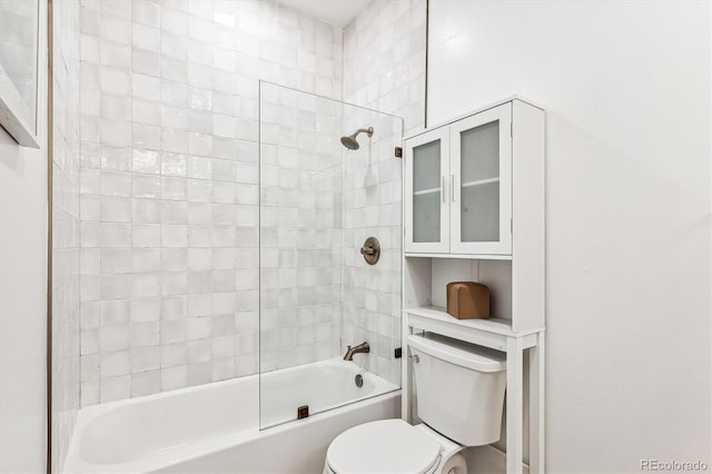 bathroom featuring toilet and tiled shower / bath combo