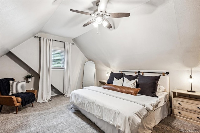 carpeted bedroom with ceiling fan and vaulted ceiling