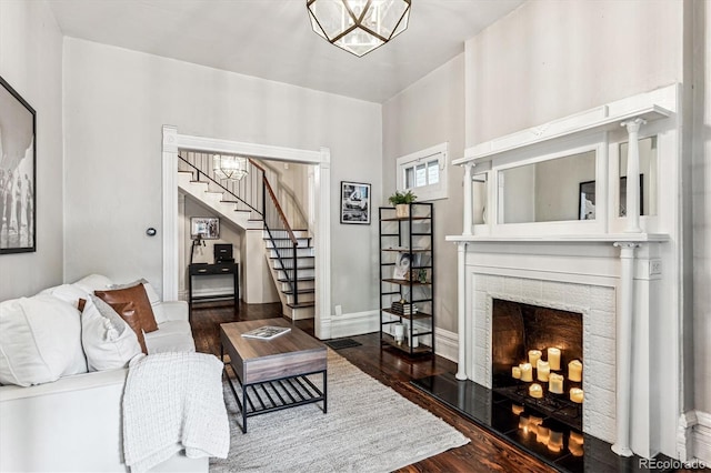 living room with dark hardwood / wood-style flooring and ornate columns