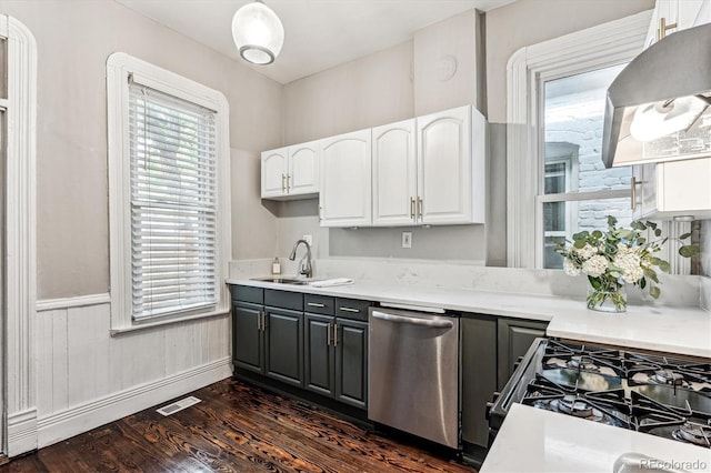 kitchen featuring gas stove, white cabinetry, sink, dark wood-type flooring, and stainless steel dishwasher