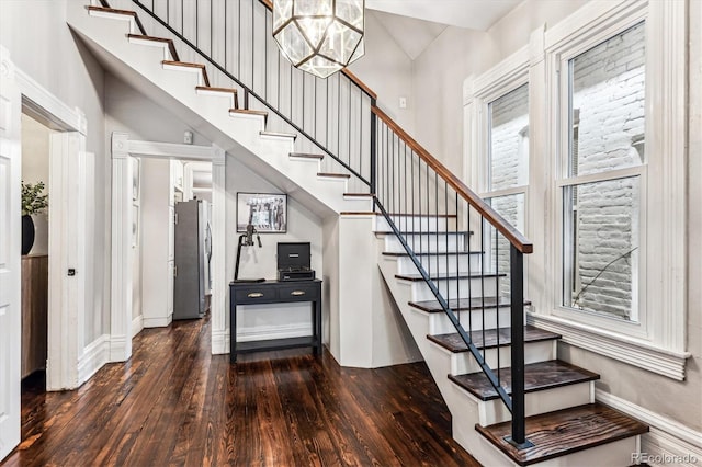 stairs featuring a notable chandelier and hardwood / wood-style flooring