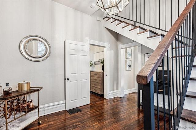 interior space with dark hardwood / wood-style floors and an inviting chandelier