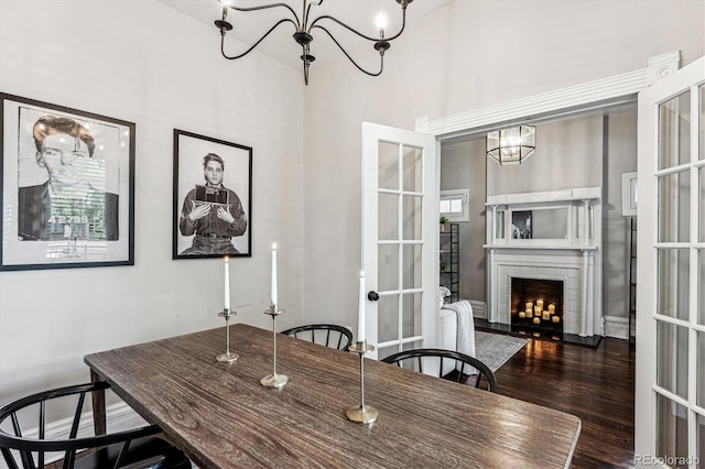 dining space featuring a fireplace, french doors, and dark hardwood / wood-style flooring