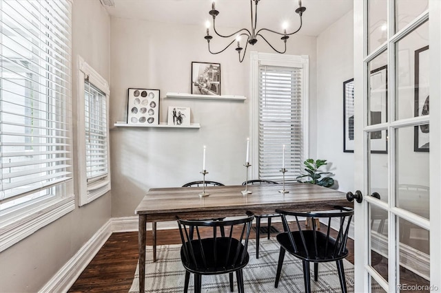 office area featuring dark hardwood / wood-style flooring, a healthy amount of sunlight, and an inviting chandelier