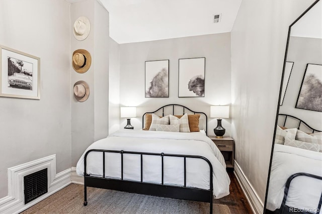 bedroom with dark hardwood / wood-style floors