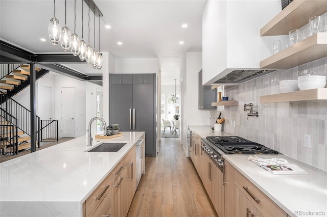 1117 S Madison St, Denver, CO 80210 - kitchen featuring open shelves, a sink, tasteful backsplash, stainless steel gas cooktop, and a large island with sink