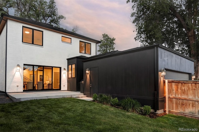 1117 S Madison St, Denver, CO 80210 - back of property at dusk featuring a lawn