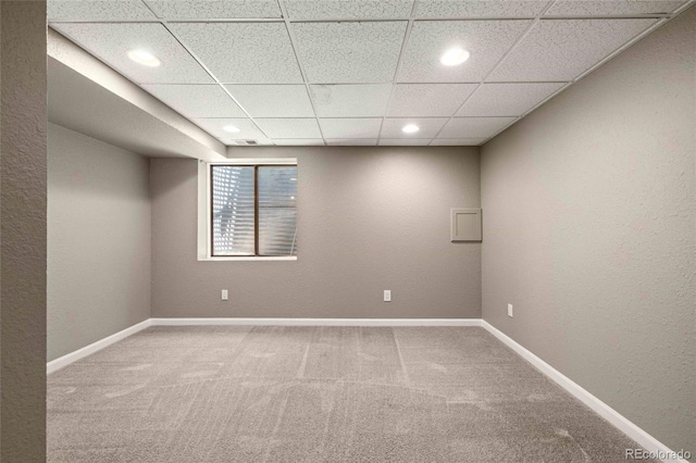 interior space with baseboards, a drop ceiling, carpet flooring, and recessed lighting