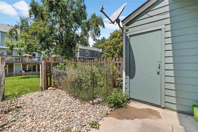 exterior space featuring an outbuilding and fence