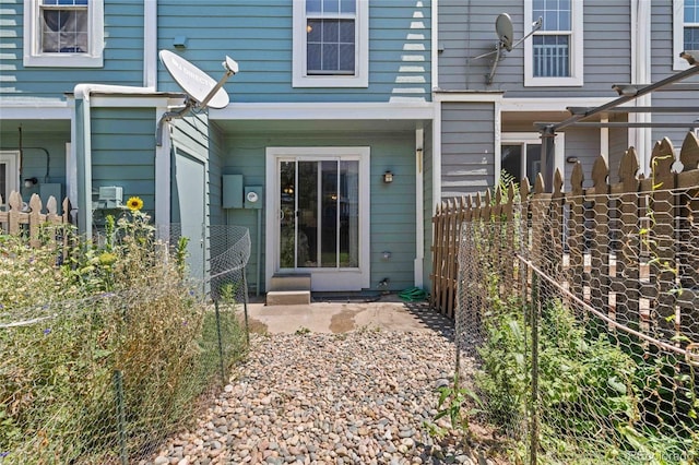 doorway to property featuring fence