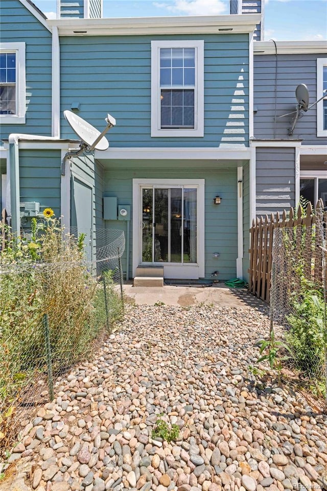 rear view of property featuring fence