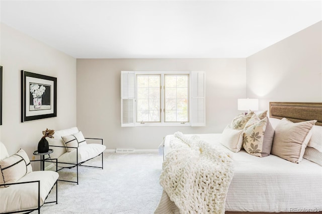 bedroom featuring visible vents, carpet flooring, and baseboards
