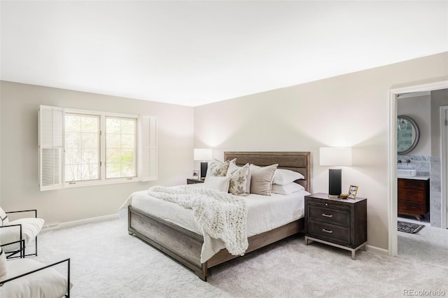 bedroom with baseboards and light colored carpet