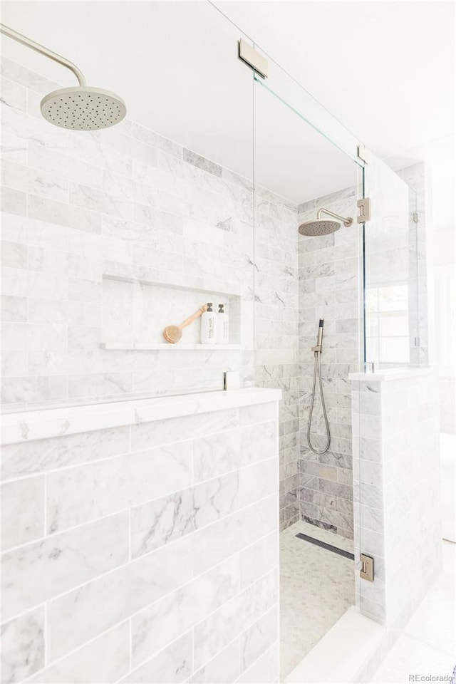 full bath with a tile shower