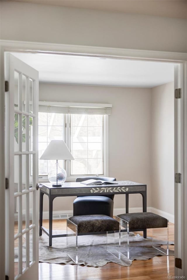 home office featuring baseboards and wood finished floors