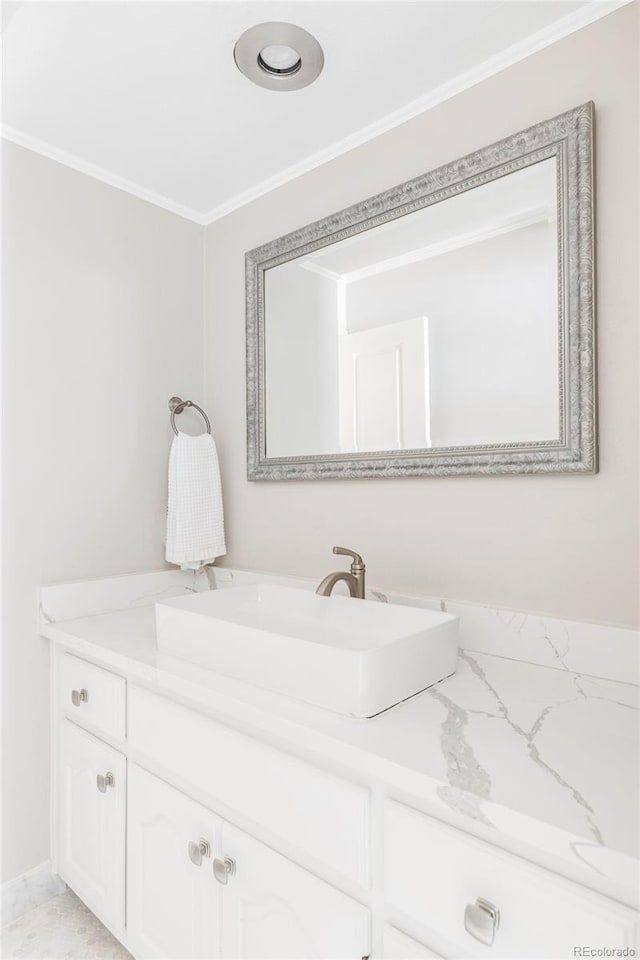 bathroom with crown molding and vanity