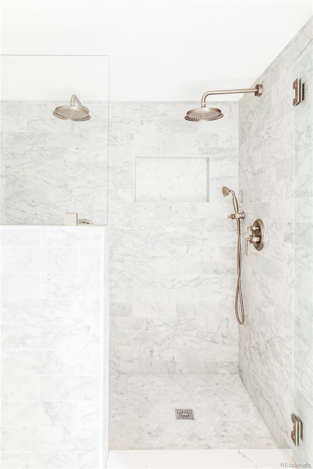 bathroom with tiled shower
