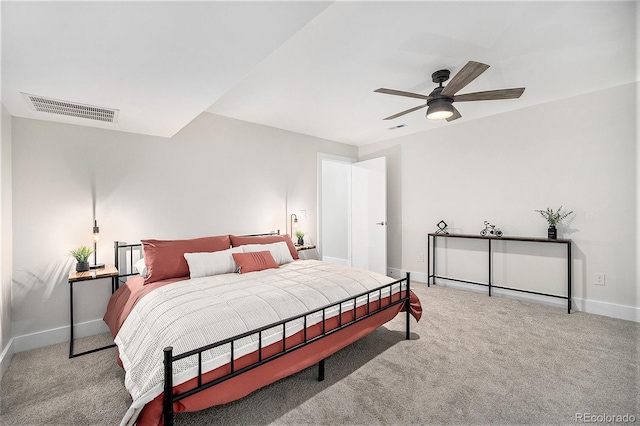 carpeted bedroom with baseboards, visible vents, and a ceiling fan