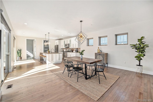 dining area with recessed lighting, baseboards, visible vents, and light wood finished floors